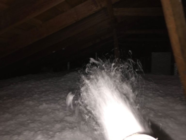 Attic insulation installation with blown-in insulation and HVAC ductwork in Texas home